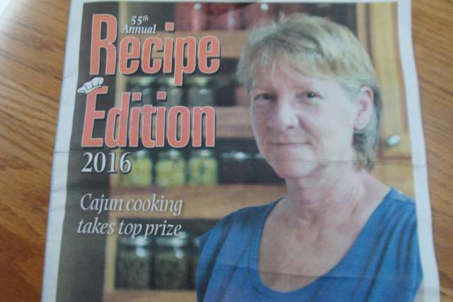 A magazine with a picture of a woman in a kitchen.