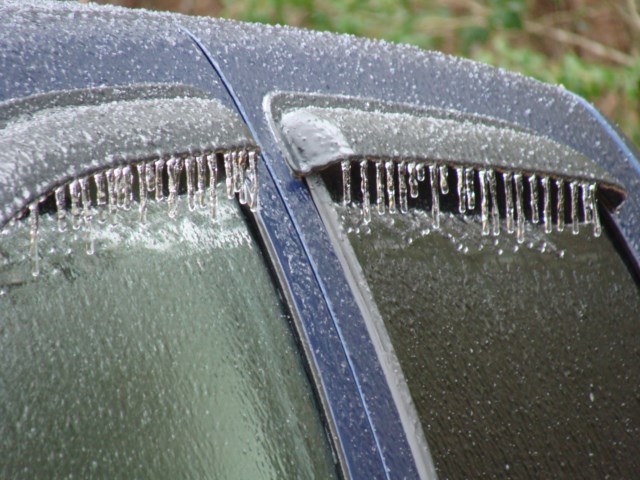 Icicles on the windows of a car.