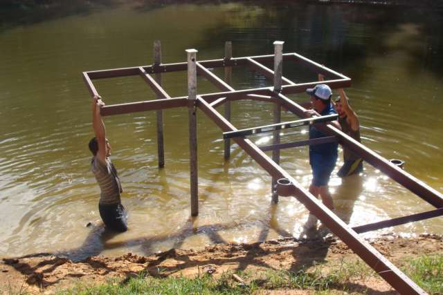 A group of people working on a structure in the water.