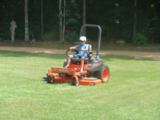 A person riding a lawn mower.